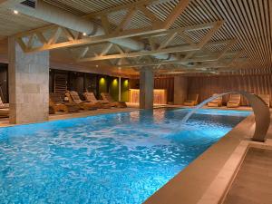 a large swimming pool with a water fountain at ETER Hotel in Golem