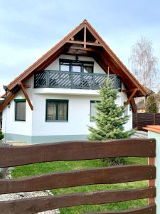 a house with a fence in front of it at Levendula Vendégház in Bük