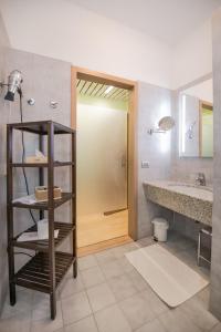 a bathroom with a shower and a toilet and a sink at Hotel Astoria Gallarate in Gallarate