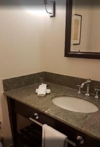 a bathroom with a sink and a mirror at Sprowston Manor Hotel, Golf & Country Club in Norwich