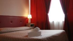 Postel nebo postele na pokoji v ubytování Ankon Hotel