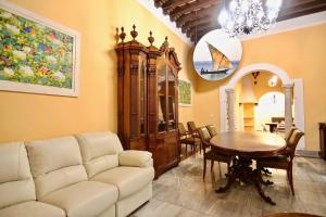 a living room with a couch and a table at El Palacete del Puerto in El Puerto de Santa María