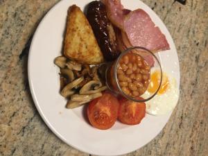 a plate of breakfast food with eggs beans and toast at The Swallows in Seend