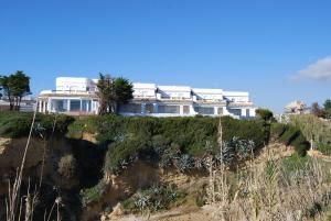 a large house on top of a cliff at Villas Flamenco Beach Conil in Conil de la Frontera