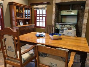 a kitchen with a wooden table with a bowl on it at Celebratio Pomegranate Farm in Oudtshoorn