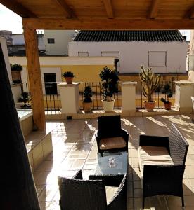 a patio with chairs and tables on a roof at B&B Nazareth in Barletta