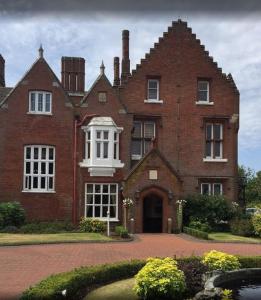 a large red brick building with a white window at Sprowston Manor Hotel, Golf & Country Club in Norwich