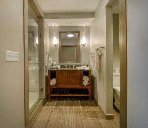 a bathroom with a sink and a shower and a mirror at Chautauqua Harbor Hotel - Jamestown in Celoron