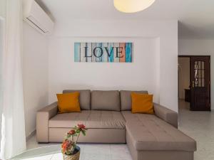 a living room with a couch and a sign that says love at Villa Galé 600m from the beach by Interhome in Patroves