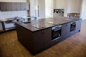 a kitchen with a large island in the middle at Ubytovňa Milex in Nové Mesto nad Váhom