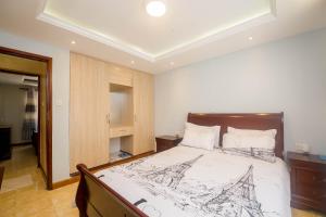 a bedroom with a bed with a drawing on it at Esterina Suites in Nairobi