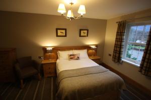 a bedroom with a bed and a lamp at The Coledale Inn in Keswick