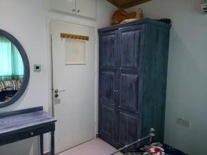 a room with a large wooden cabinet next to a door at Wooden House in Paphos City +12 photos