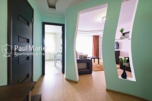 a living room with a couch and a mirror at PaulMarie Apartments on Shahterov in Salihorsk