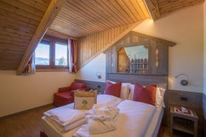 a bedroom with a bed with a bag on it at Relax Hotel Erica in Asiago