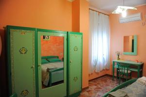 a bedroom with green cabinets with a bed in it at B&B Antoclo Di Concas Angela Margherita in Villacidro