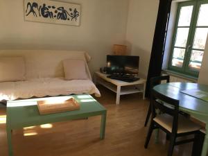 een woonkamer met een bed en een tafel met een boek bij allees des soupirs in Cahors