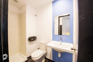 a bathroom with a white toilet and a sink at Safestay Athens Monastiraki in Athens