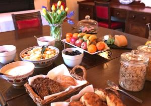a table topped with baskets of different types of food at Delphi Lodge in Leenaun