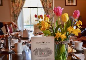 a vase filled with flowers sitting on a table at Delphi Lodge in Leenaun