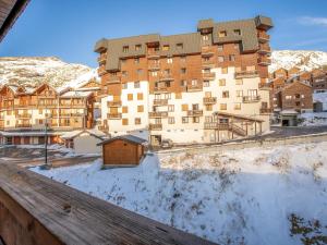 a view of a large building in the snow at Apartment Neves-5 by Interhome in Val Thorens