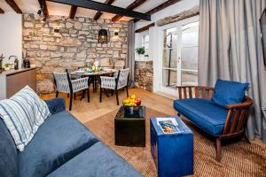 a living room with a blue couch and a table at Dal Pescatore in Rovinj