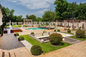 a backyard with a swimming pool and a playground at Hotel Bellavista Deta in Deta