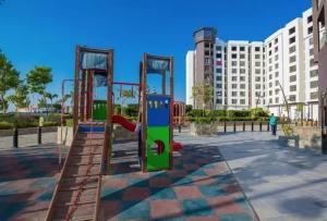 a playground with a slide in front of a building at The Resort Chalet- Porto New Cairo in Cairo