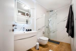 a white bathroom with a toilet and a shower at Dal Pescatore in Rovinj +30 photos