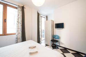 a room with a bed and a chair and a window at Safestay Athens Monastiraki in Athens