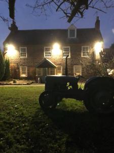 a large brick house with lights in front of it at Park Farm in Gateshead