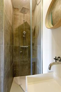 a shower with a glass door in a bathroom at Ty Mad in Douarnenez