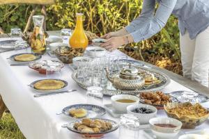 a table with plates of food on it at Diar illi in Touama