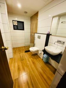 a bathroom with a sink and a toilet at Saluja Residency in Siliguri