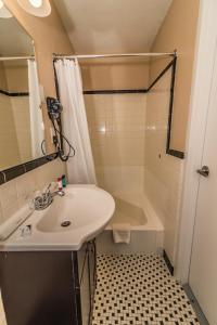 a bathroom with a sink and a shower and a tub at The Minuteman Inn Acton Concord Littleton in Acton