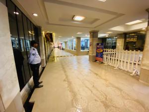 a person standing in a hallway of a building at Saluja Residency in Siliguri