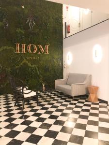 a room with a couch and a checkered floor at Suites Hom Sevilla in Seville