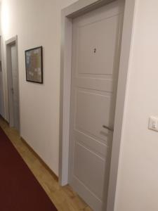 a white door in a hallway with two rooms at Affittacamere Iris in Trieste