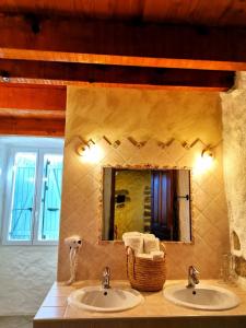 a bathroom with two sinks and a mirror at L'Aghjalle in Santa-Reparata-di-Balagna +48 photos