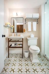 a bathroom with a toilet and a sink at The Savoy Hotel & Beach Club in Miami Beach