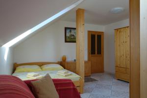 a bedroom with a bed and a staircase in a room at Apartmány Arnika in Horní Planá