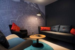 a living room with a couch and a table at Holiday Inn Express Edinburgh - Leith Waterfront by IHG in Edinburgh