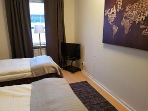 Postel nebo postele na pokoji v ubytování Hotell Skinnargården