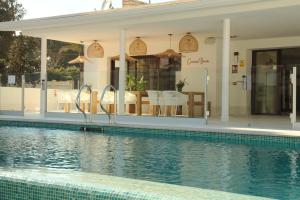 a house with a swimming pool in front of it at Alidreams Carmen Beach Apartamentos in El Campello