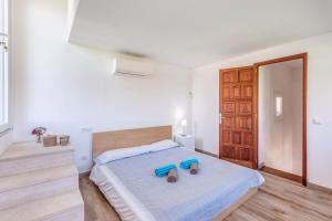 Postel nebo postele na pokoji v ubytování Villa Dos Mundos