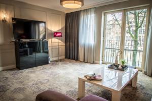 a living room filled with furniture and a fireplace at Luxury Suites Amsterdam - Member of Warwick Hotels in Amsterdam