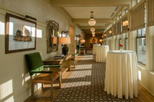 a hallway with tables and chairs in a building at Kimpton Taconic Hotel by IHG in Manchester