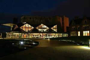 a building at night with a car parked in front at towerhill in Culloden