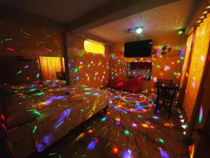 a bedroom with a bed covered in christmas lights at HOSTAL EL TORNILLO 3 in Lima