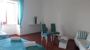 a living room with two chairs and a couch at Emidio House in Termini